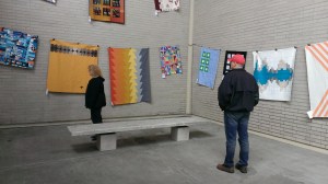 Churn Dash 2: Complementary hanging at the Seattle Modern Quilt Guild Exhibit at Folklife Festival, Seattle, May 2014 (far left)